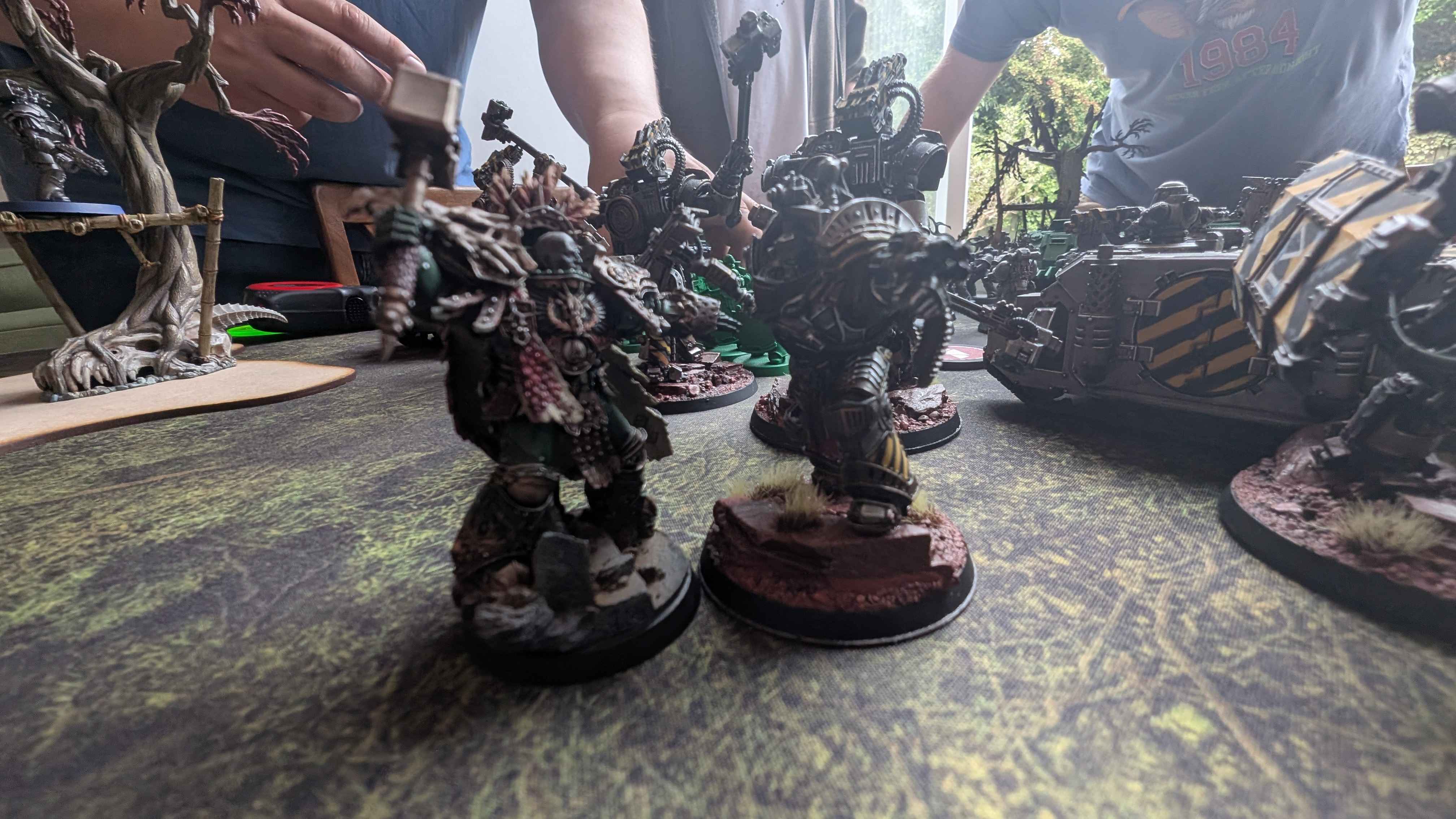 Iron Warriors infantry and a hazard-striped Rhino advance on green-armoured Salamanders